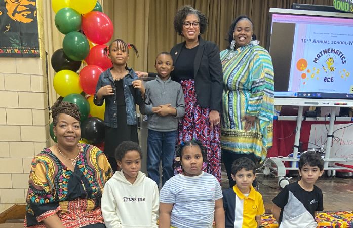  students posing with principal and staff at the math bee